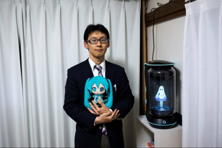 Akihiko Kondo posando al lado de su esposa, el holograma de la primera cantante virtual japonesa 