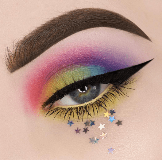 Sombra para ojos en colores amarillo, rosa, morado y verde con decorado de estrellas