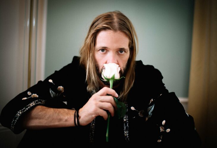 Taylor Hawkins oliendo una rosa blanca
