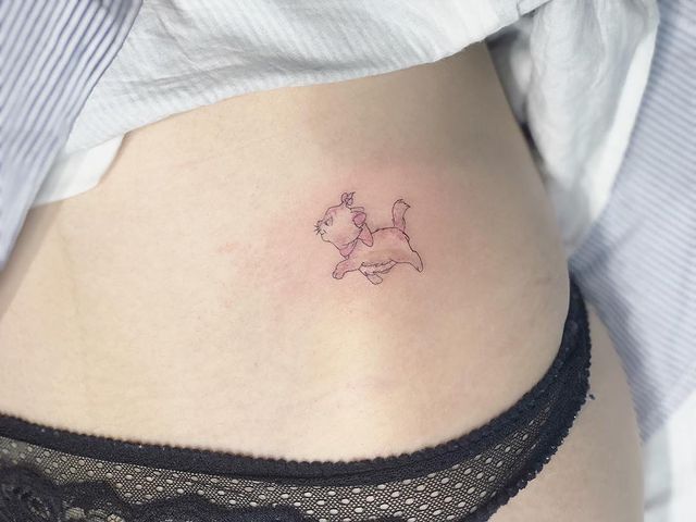 Chica mostrando un tatuaje en la cintura