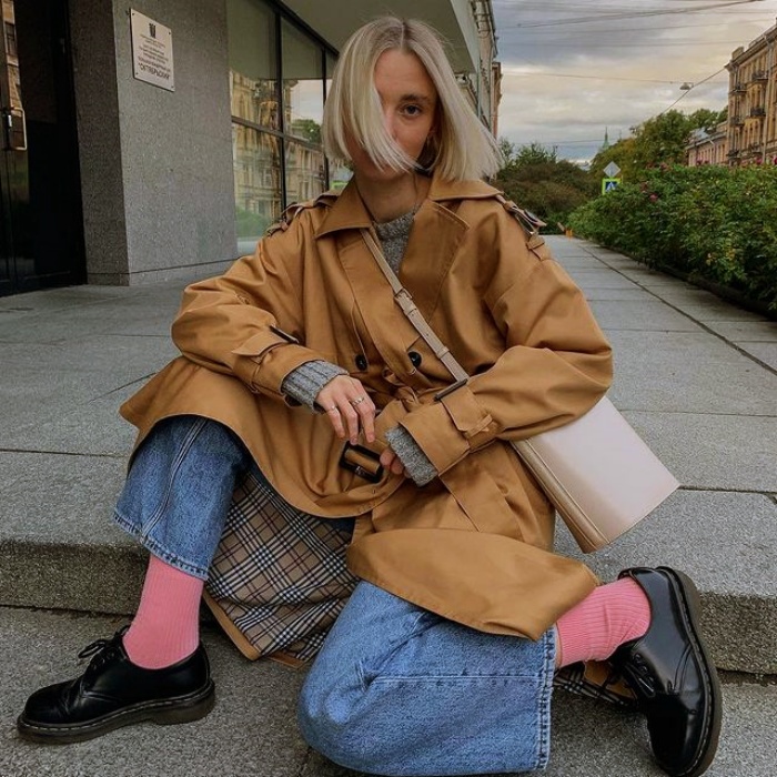 Mujer con abrigo beige y jeans