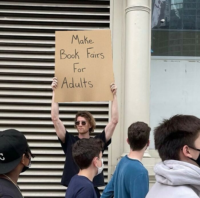 Chico protestando con un cartel en las calles de Nueva York 