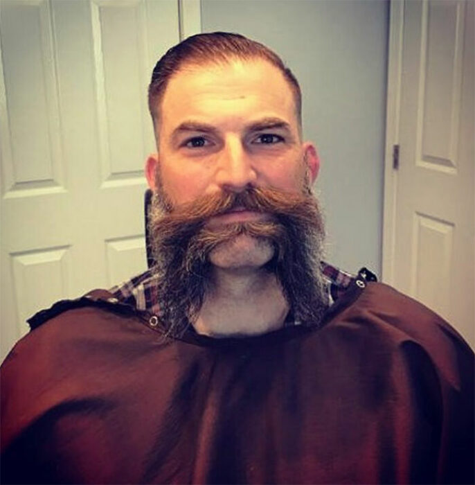 Hombres usando doble bigote en el rostro mientras lo peinan con gracia