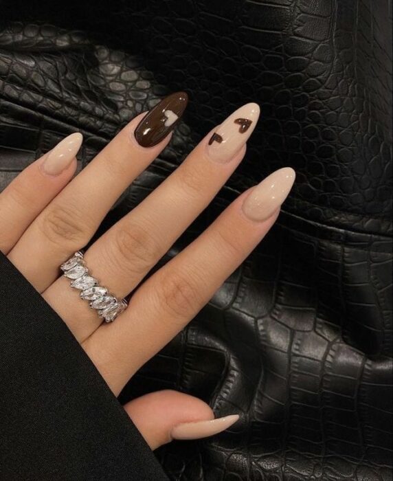 Chica con las uñas pintadas en diferentes tonos de café con nude