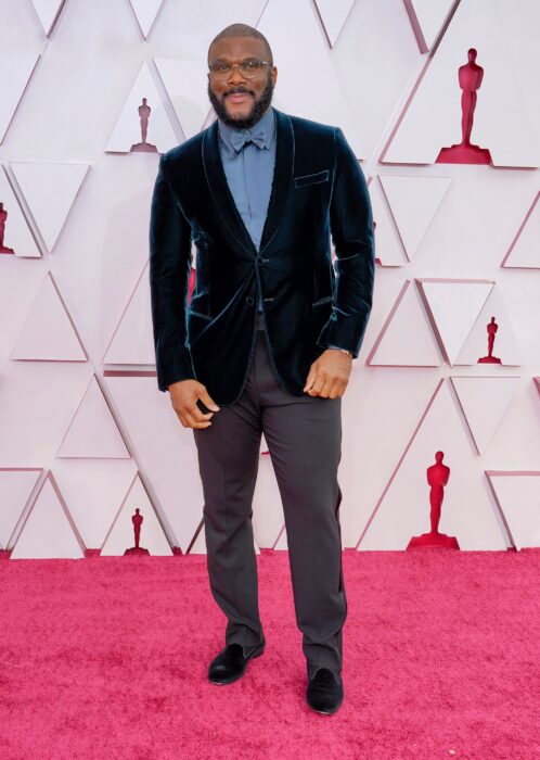 Tyler Perry usando un saco de terciopelo con camisa azul y un pantalón de color gris en la entrega de premios Óscar 2021