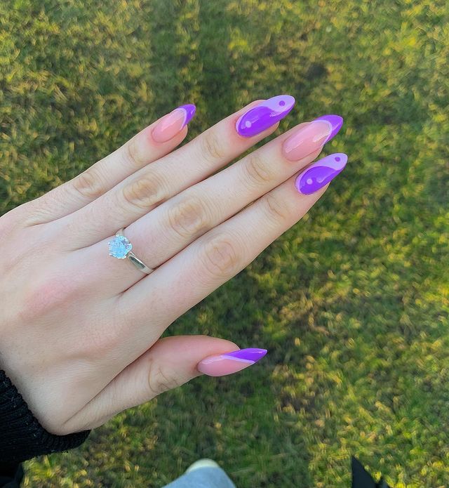 Chica mostrando sus uñas con diseño Yin Yang en color morado con rosa