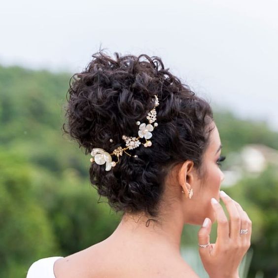 Novia de cabello rizado con recogido alto