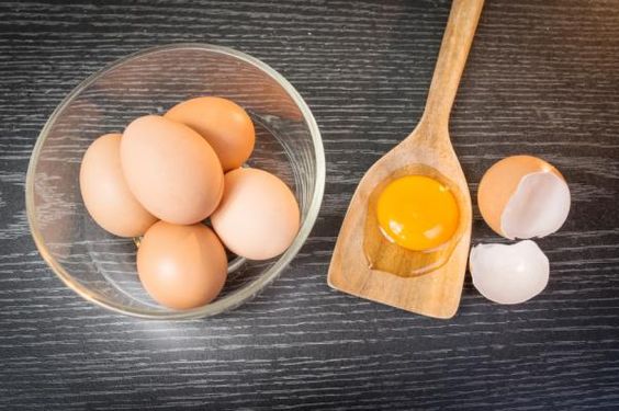 Un tazón de cristal con huevos rojos dentro