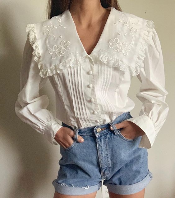 Chica con short de mezclilla y blusa blanca con cuello bobo