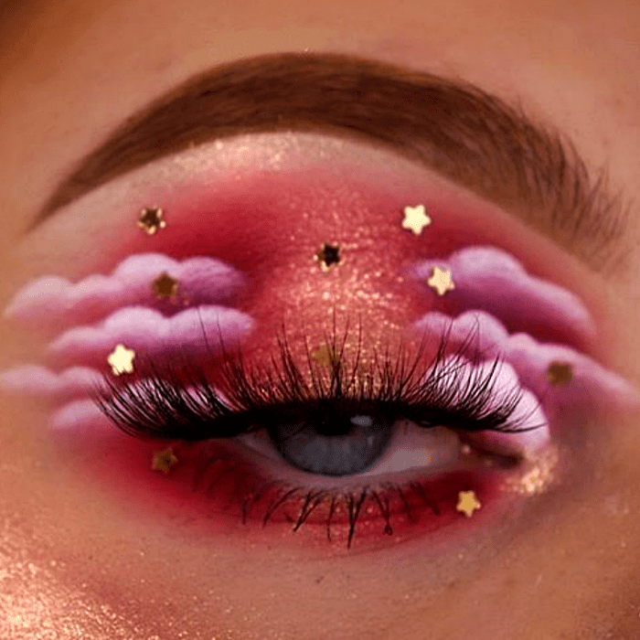 maquillaje de ojos con sombreado rosa, naranja, rojo, guinda y blanco con nubes y estrellitas