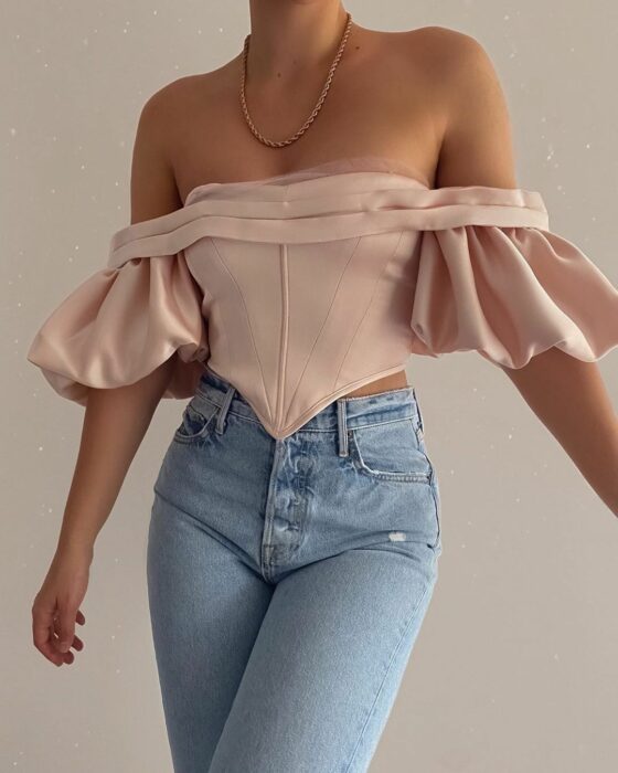 Chica con una blusa rosa estilo corsé