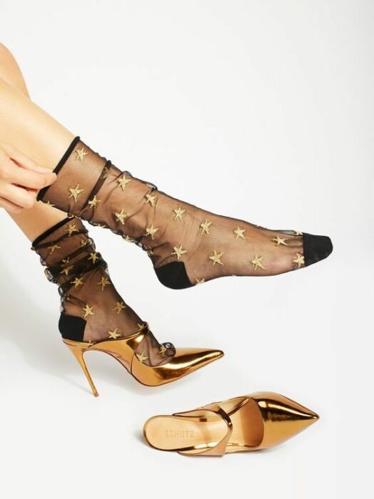 Calcetas con transparencia en negro adornadas con estrellitas doradas