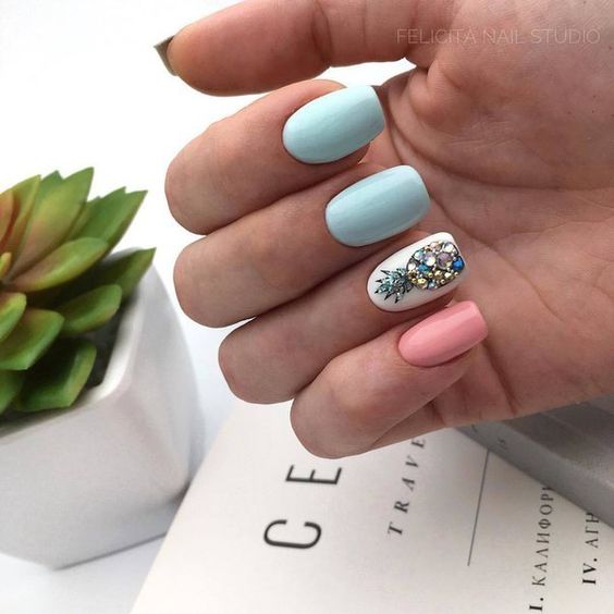Manicura en tonos blanco, rosa pastel y color menta con decorado de piña azul