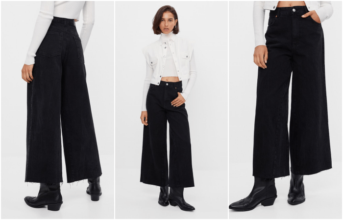 chica de cabello corto usando un top blanco, chaqueta de mezclilla blanco, pantalones acampanados negros y botines negros de tacón