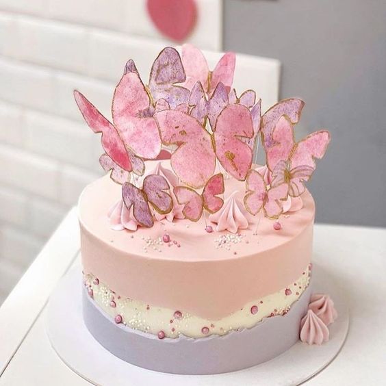 Pastel de zarzamora en colores rosa, blanco y morado, decorado con mariposas en tonos rosas; Hermosos pasteles con mariposas