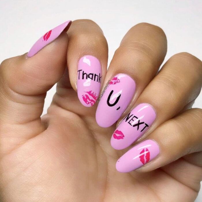 Manos con uñas largas en forma de almendra pintadas en rosa bebé, inspiradas en 'thank u, next' de Ariana Grande, con marcas de besos