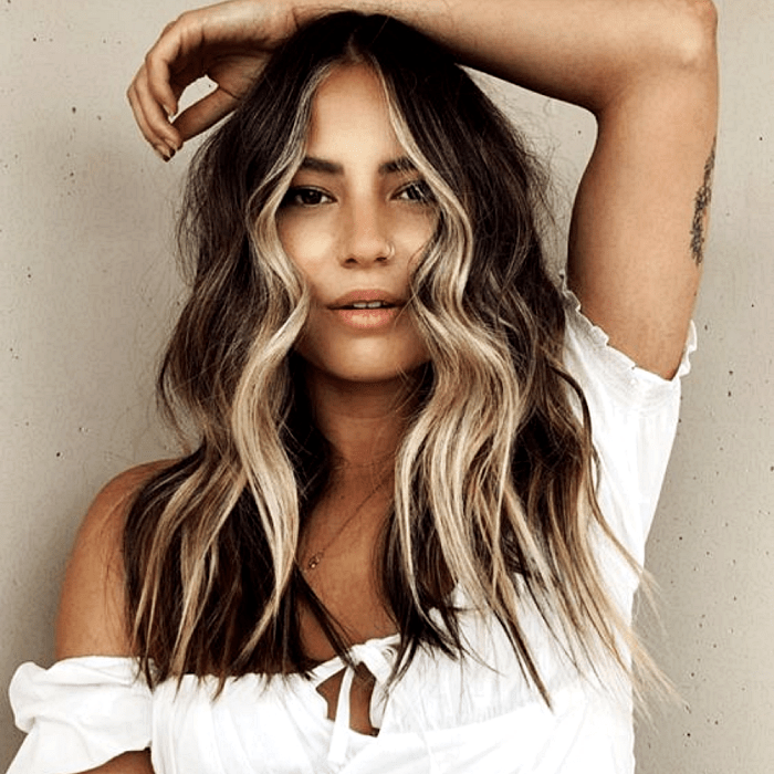 chica de cabello castaño oscuro con mechas y hightlights estilo money piece