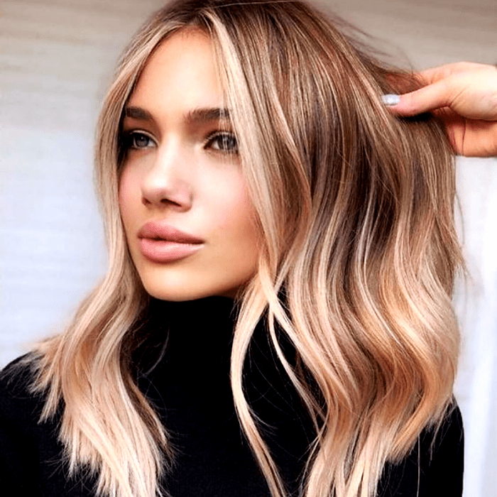 chica rubia con cabello largo claro y mechas con highlights estilo money piece