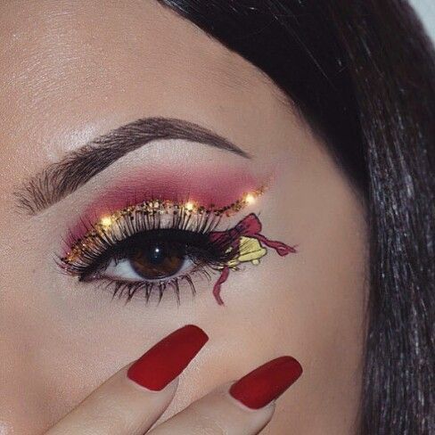 Chica con maquillaje de ojos en color dorado con rojo; Maquillajes lindos para celebrar Navidad