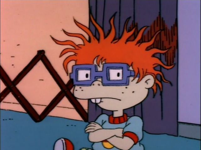 Carlitos de Rugrats sentado en la sala de Tommy y enojado
