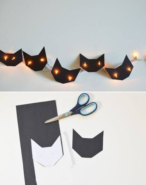 Gatitos de papel negro con luces