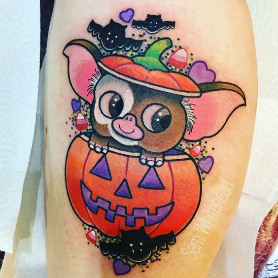 Tatuaje en forma de gremlin saliendo de una calabaza