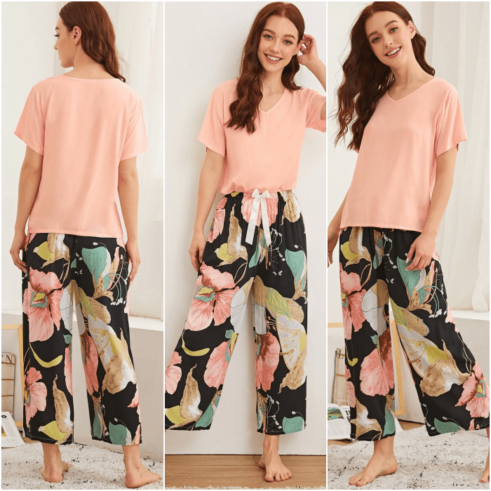 chica pelirroja usando una pijama de camiseta rosa de manga corta, pantalones holgados negros con estampado de flores grandes