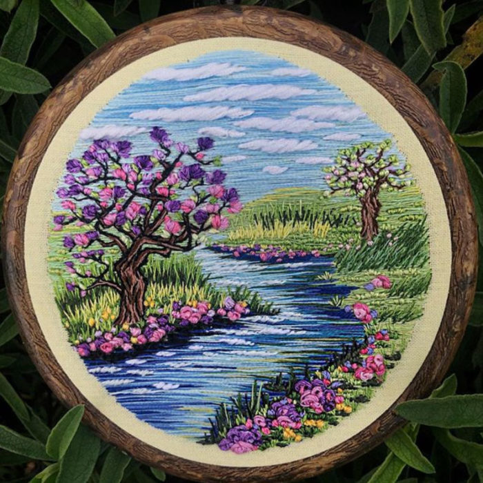 Bordado en aro hecho a mano de un árbol de cerezo a la orilla de un río