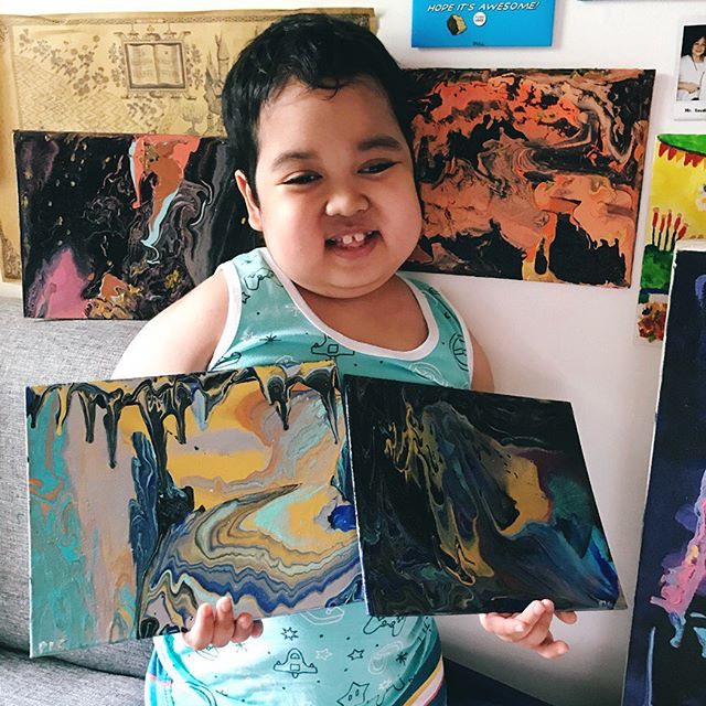 Aeden mostrando algunas de las pinturas que ha hecho