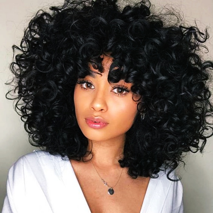 chica morena con cabello chino color negro azabache 