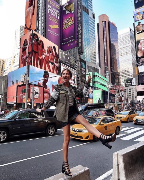 Chica feliz posa en avenida de Nueva York