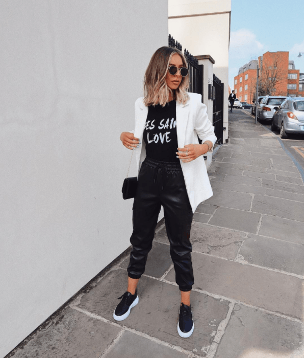 Chica con un outfit inspirado en Lara Jean que incluye un traje negro y blazer blanco
