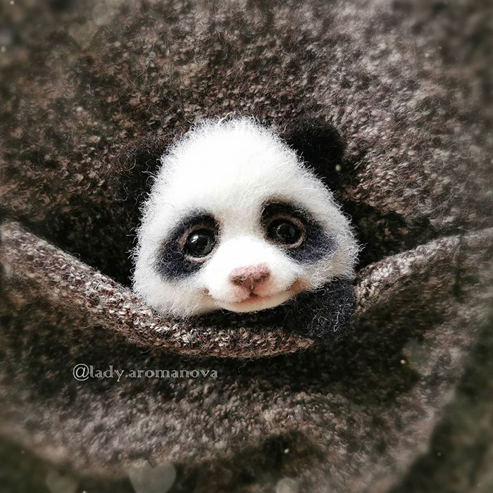 Figura de fieltro creada por la artista rusa Anna Romanova panda pequeño dentro de un saco gris