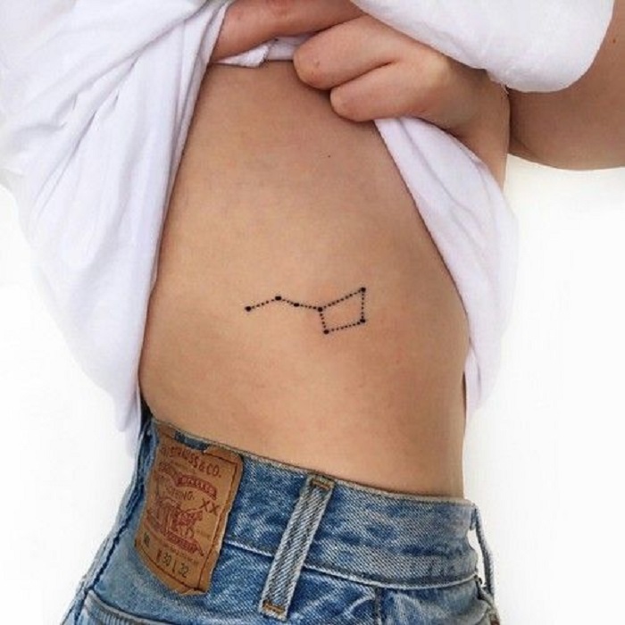 Tatuaje de constelación en la parte del costado a la altura del busto
