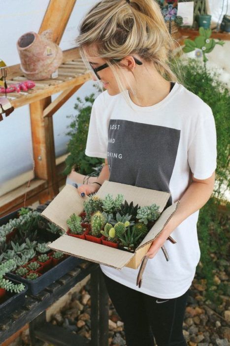 Chica cuidando plantas de su jardín