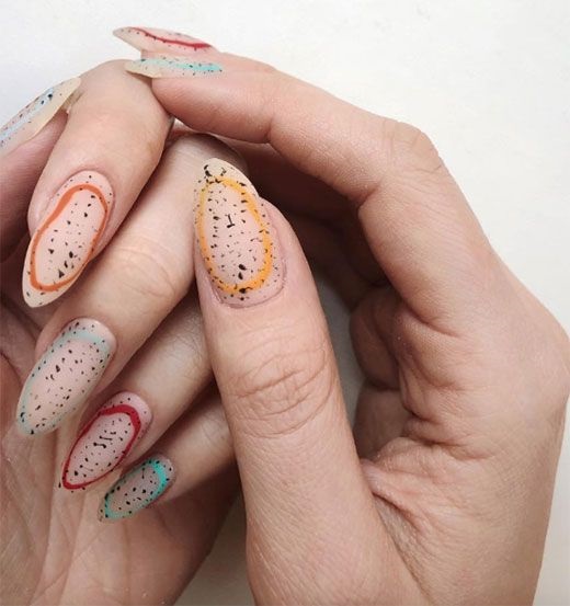 Manicura con borde negro y puntos inspirados en huevos de dinosaurio