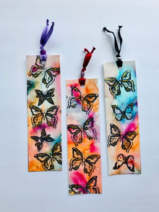 Separadores de libro con fondo estilo acuarela y mariposa a tinta negra en la parte superior