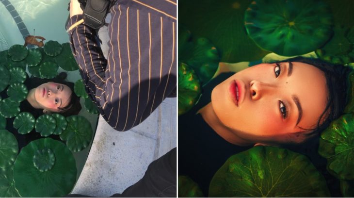 Detrás de cámaras de fotografía de modelo dentro de una fuente con hojas alrededor de su rostro