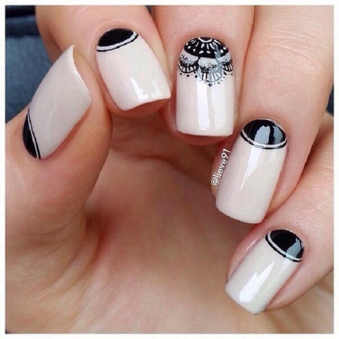 Manicura en tono beige con detalles y pequeño mandala en negro