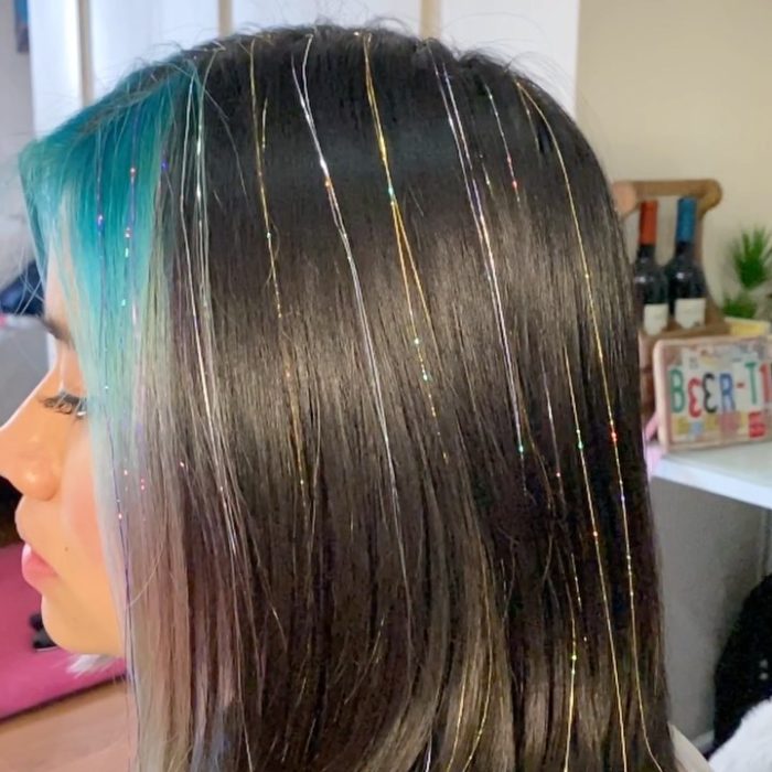 Chica con extensiones de glitter en color rosa y plateado