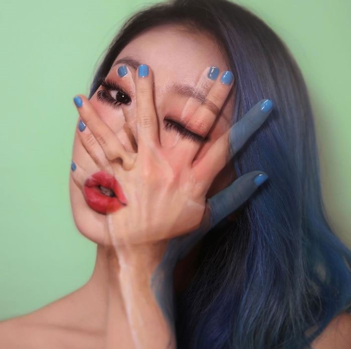 Dain Yoon, artista maquillaje, pintura recreando sus manos sobre su trostro