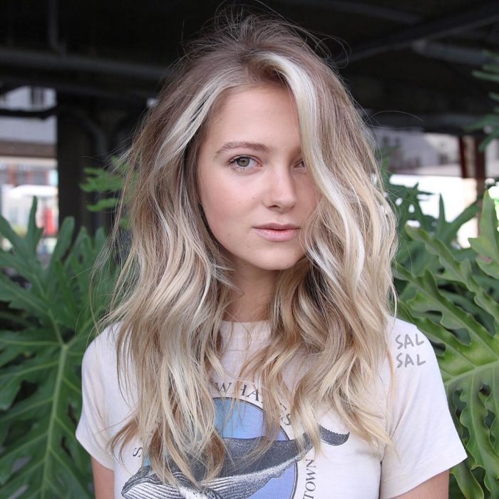 Chica con cabello rubio cenizo con tintes amarillos