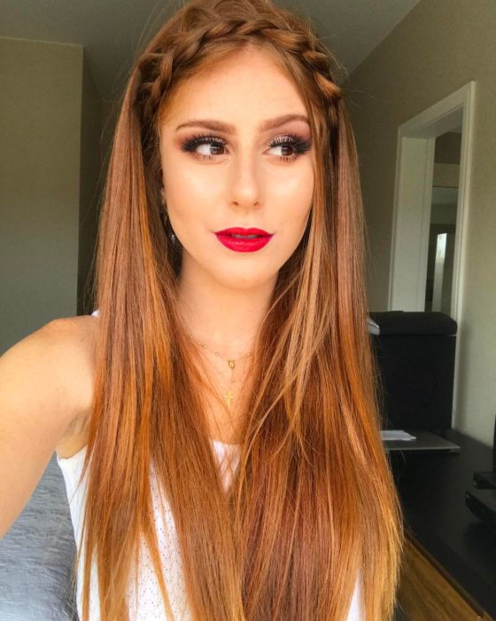 Chica con el cabello sujetado en una trenza que tiene diadema