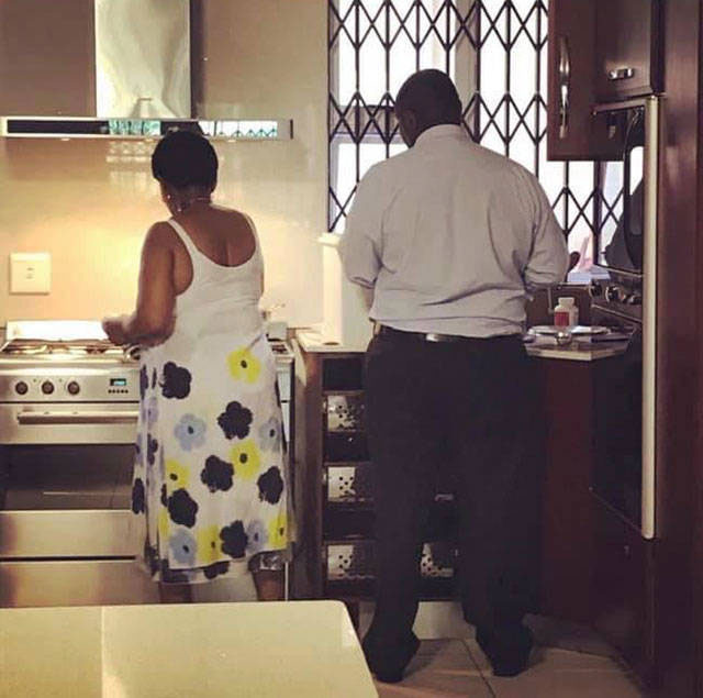 Pareja de adultos lavando platos en una cocina