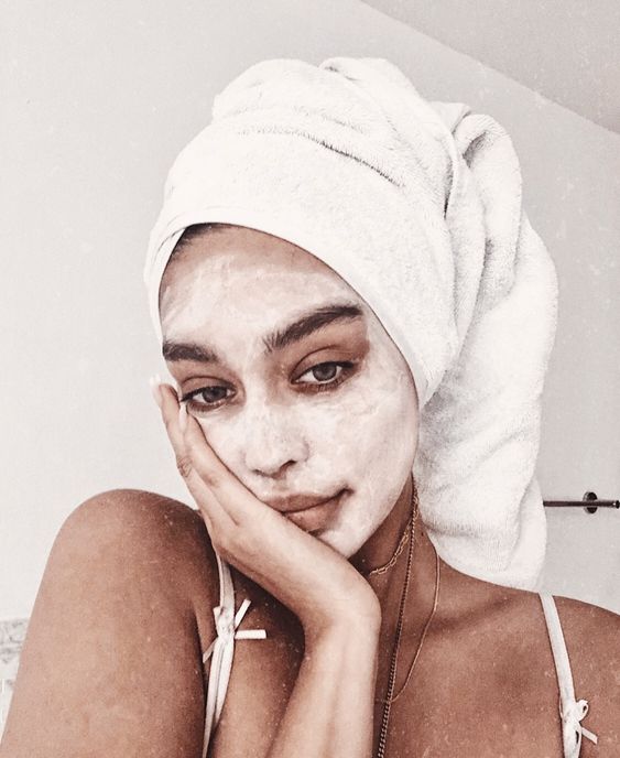 Chica usando mascarilla de harina de avena y recargada sobre la palma de su mano 