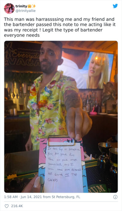 Camarero dando un recibo a una clienta en un bar