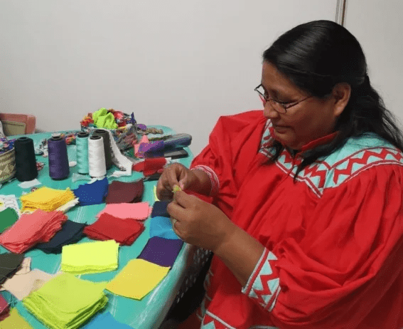 Mujer rarámuri haciendo cubrebocas